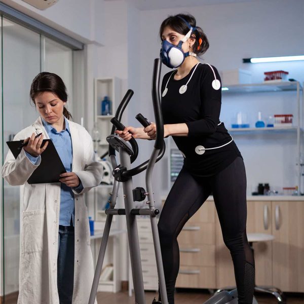 Athlete runner woman wearing medical electrodes working at body endurance
